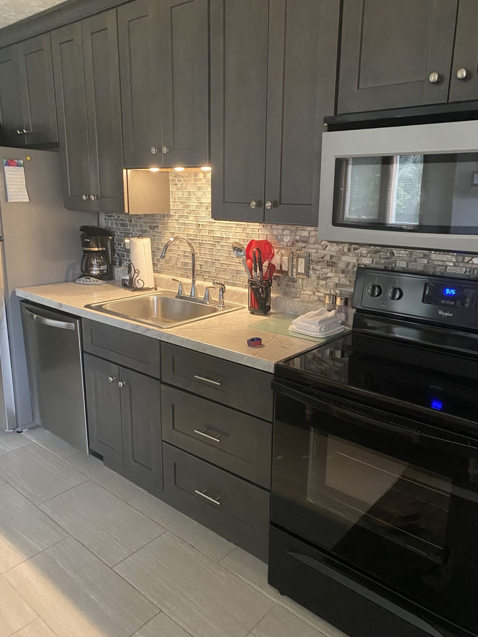Kitchen with oven. stove, microwave, dishwasher, & coffee maker.