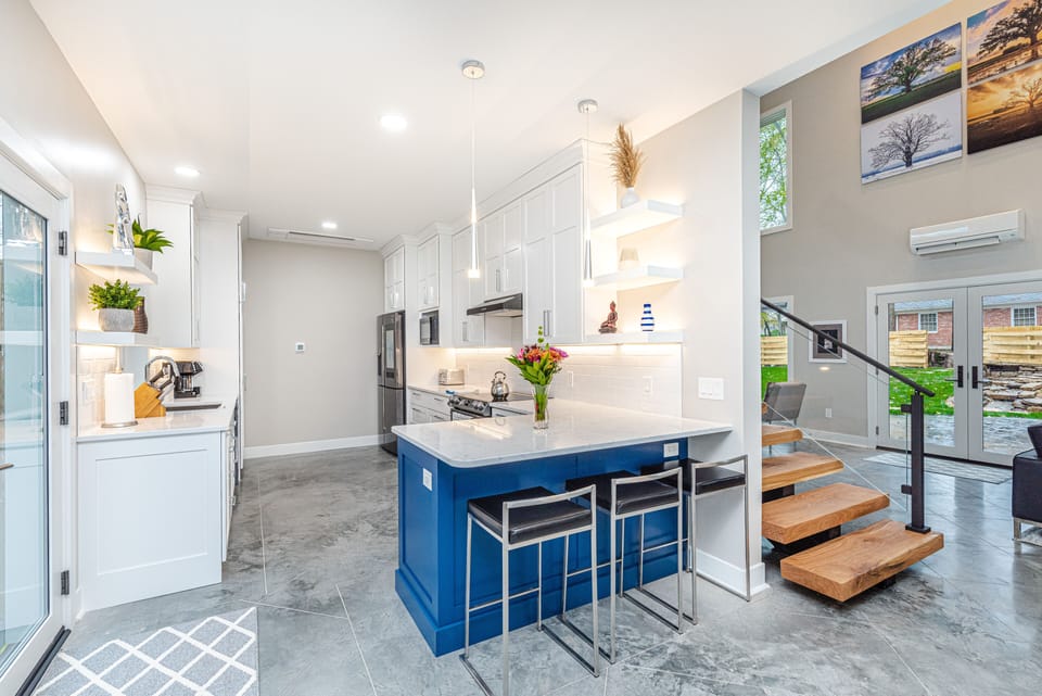 kitchen island, bar stools, floating shelves, pendants
