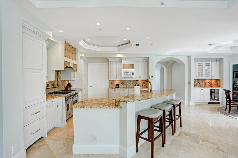 Open-concept kitchen equipped with utensils, dishware, cookware and more
