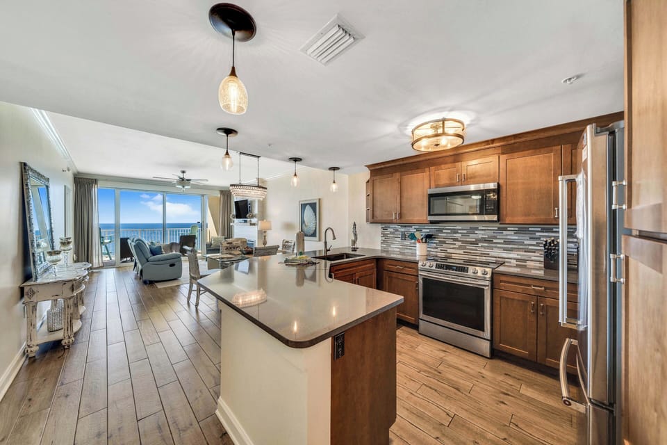 The fully equipped kitchen features quartz countertops, stainless-steel appliances, and has everything you need to prepare meals for family & friends.