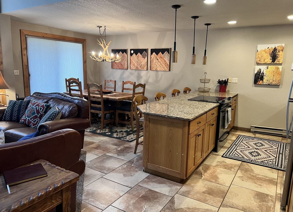 Open concept kitchen, dining and living area. Balcony off dining. 
