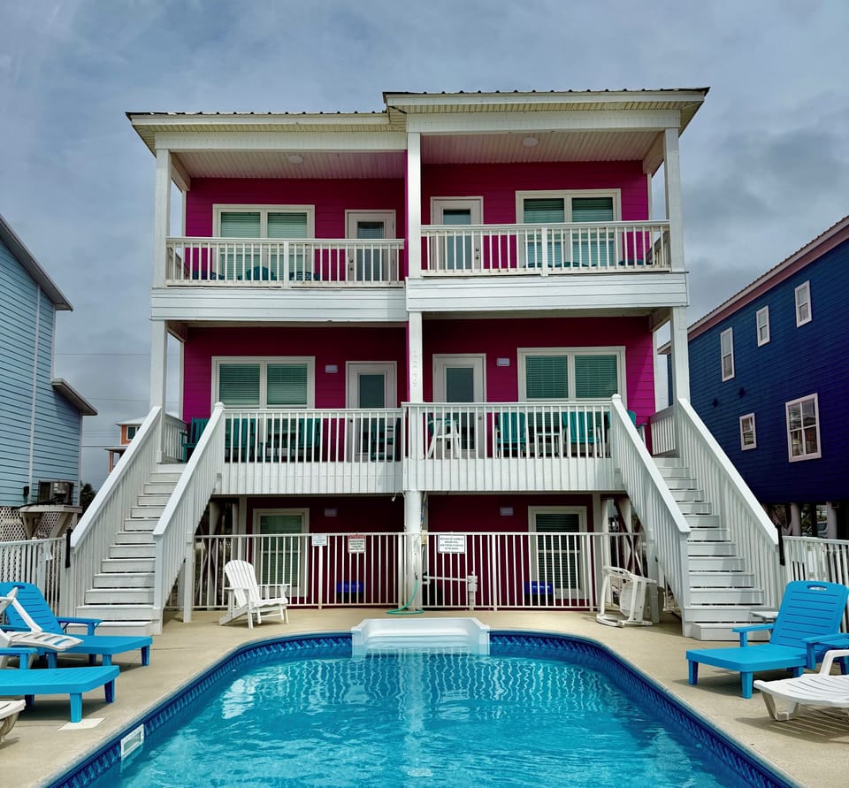 Back of house with big pool