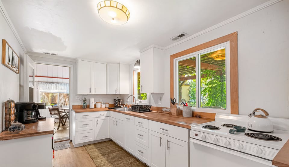 Bright and rustic kitchen with butcher block counters. Fully equipped.