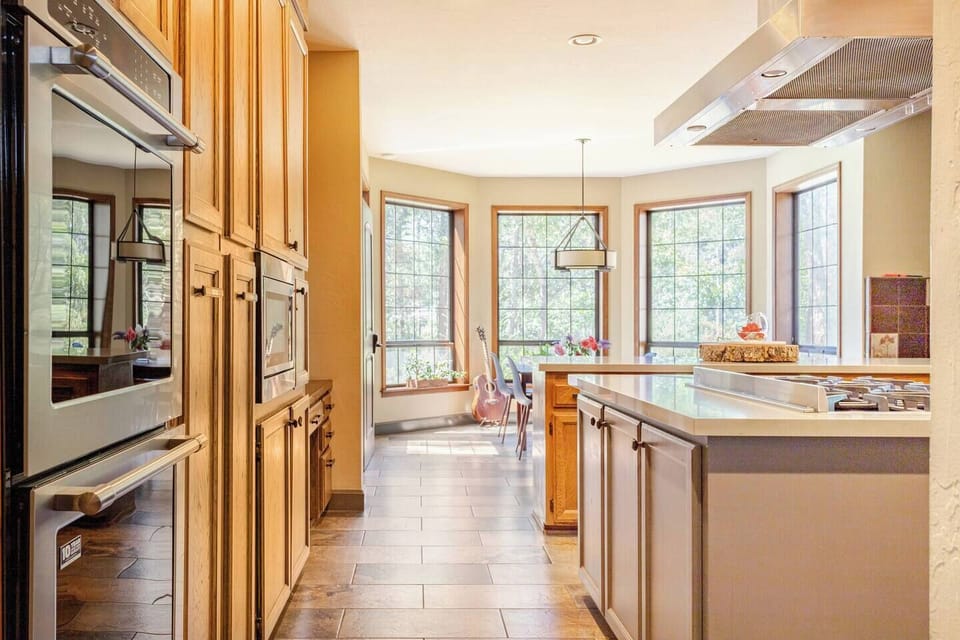 Kitchen with 10-seat dining table, fridge, double oven, toaster, coffee machine