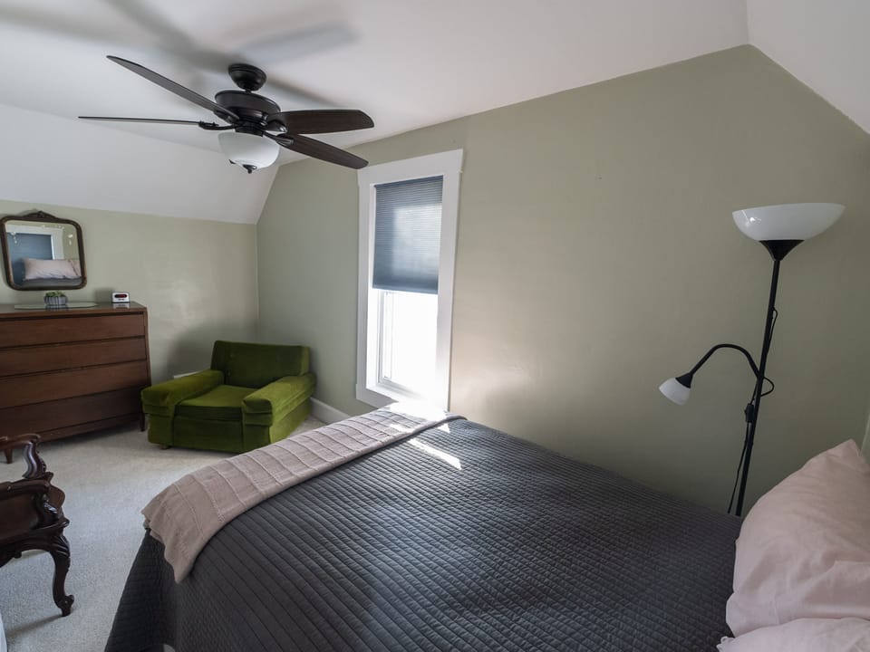 The Northwest bedroom is sunny and warm with a full sized bed and sitting area.