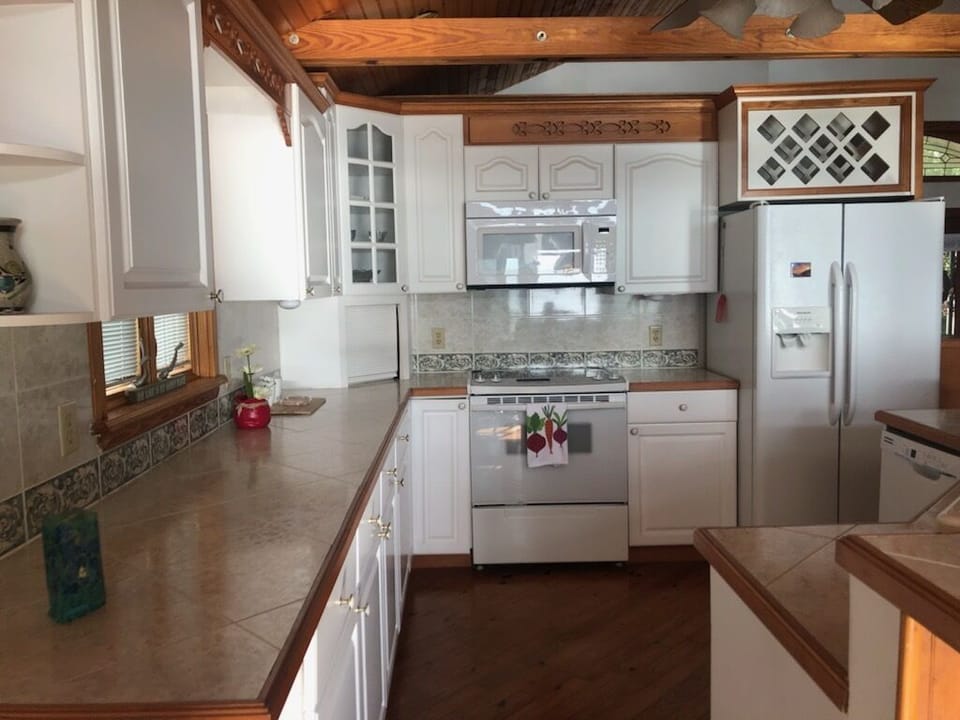 Full kitchen with breakfast bar open to living area.