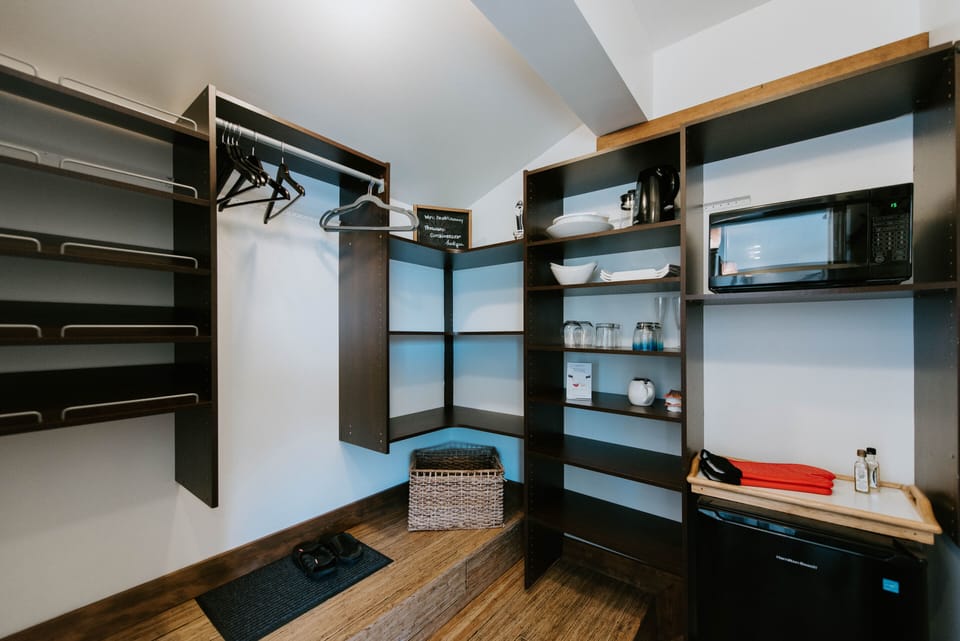Bar Fridge, microwave, closet, supply area