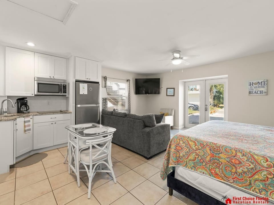 Bright open studio with cozy bed and modern kitchen