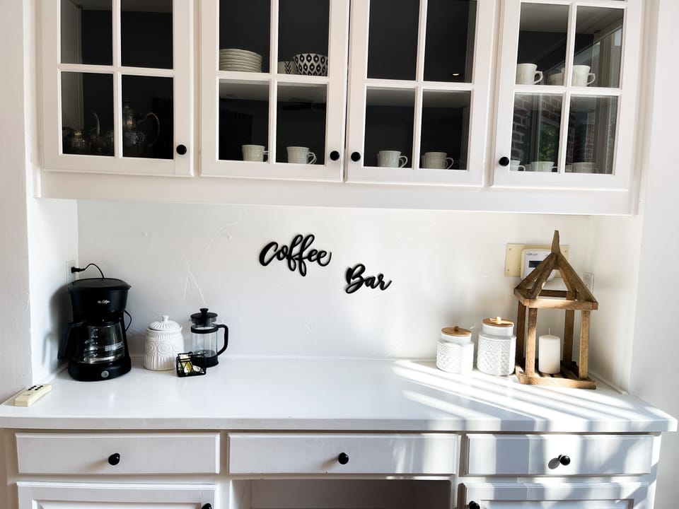 Coffee bar with a drip pot and french press. Creamer, sugar and coffee included.