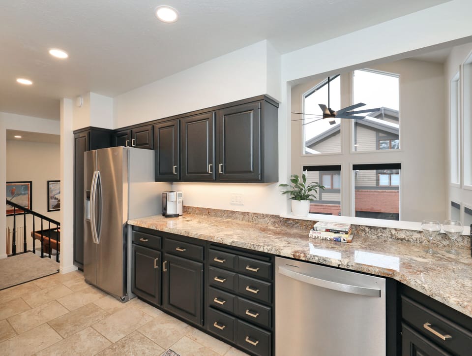 Fully stocked kitchen with lookout into living room.
 