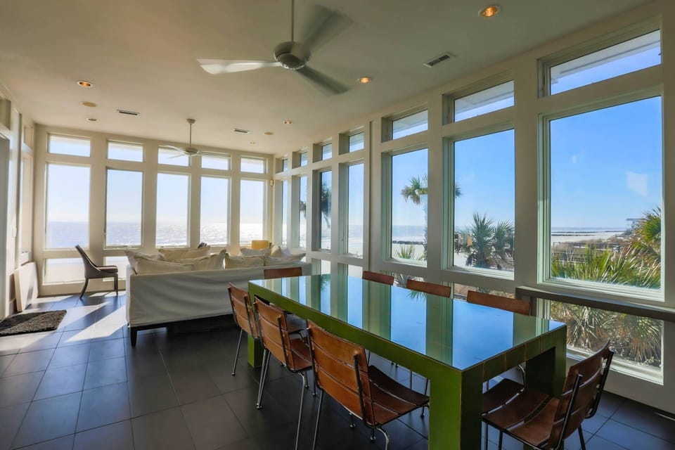 The dining table seats 8 and there are 4 stools at the kitchen island.