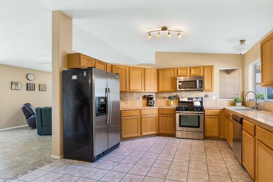Open kitchen has great natural lighting and tile