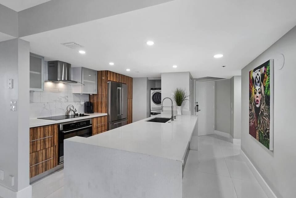Fully equipped kitchen with washer/dryer, front entry to condo 