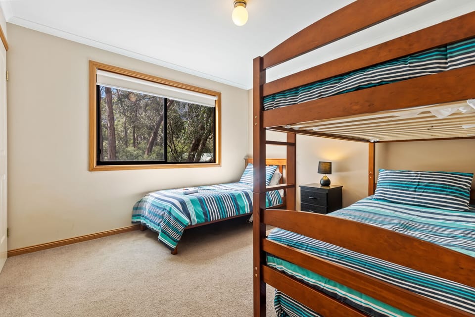 Bedroom 3: Versatile and cozy with four beds, ideal for groups or families.
