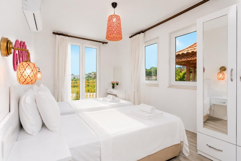Twin bedroom with en suite bathroom, A/C, and balcony access