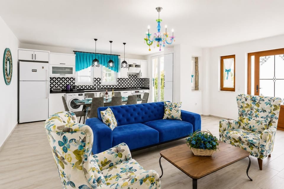 Open-plan living room with sofas, dining area, kitchen, A/C, WiFi internet, satellite TV, and terrace access