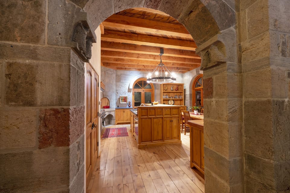 Entry to the kitchen in the evening through the stone archway.