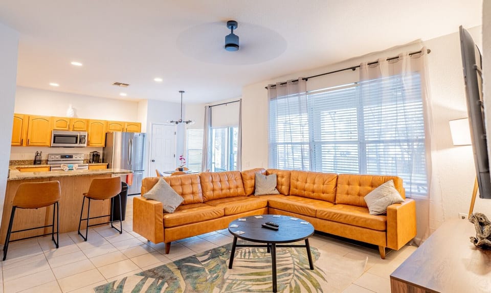 Stylish lounge area with flat screen Smart TV and sliding doors to the pool deck