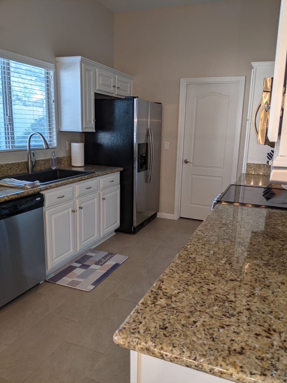 Fully stocked galley kitchen has stainless steel appliances
