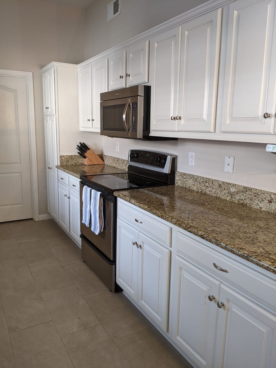 Galley kitchen has granite countertops