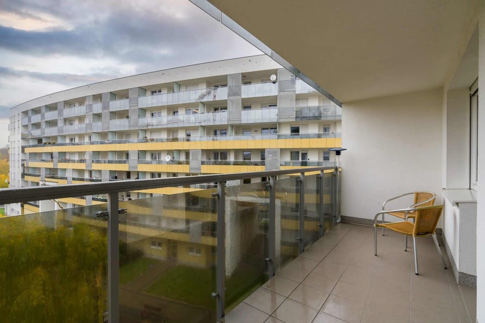 The balcony's stylish design complements the apartment's decor. 