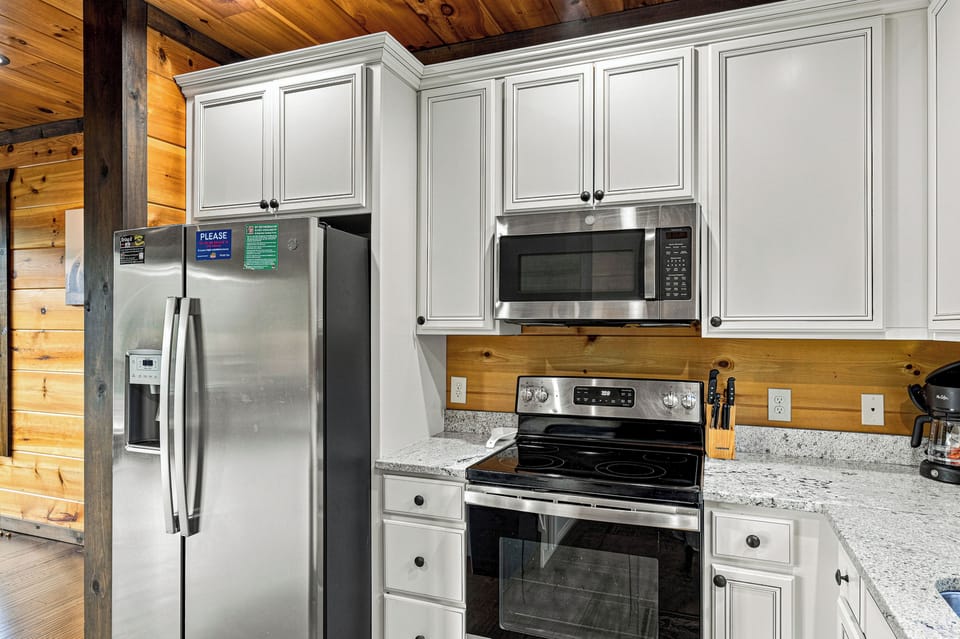 Kitchen includes cookware, dinnerware, cutlery, & bakeware.