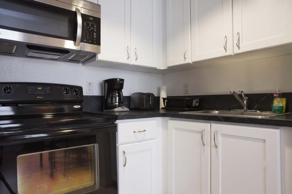 Whip up meals in this tidy Airbnb kitchen with all the essentials—great for short-term rentals and cozy stays.