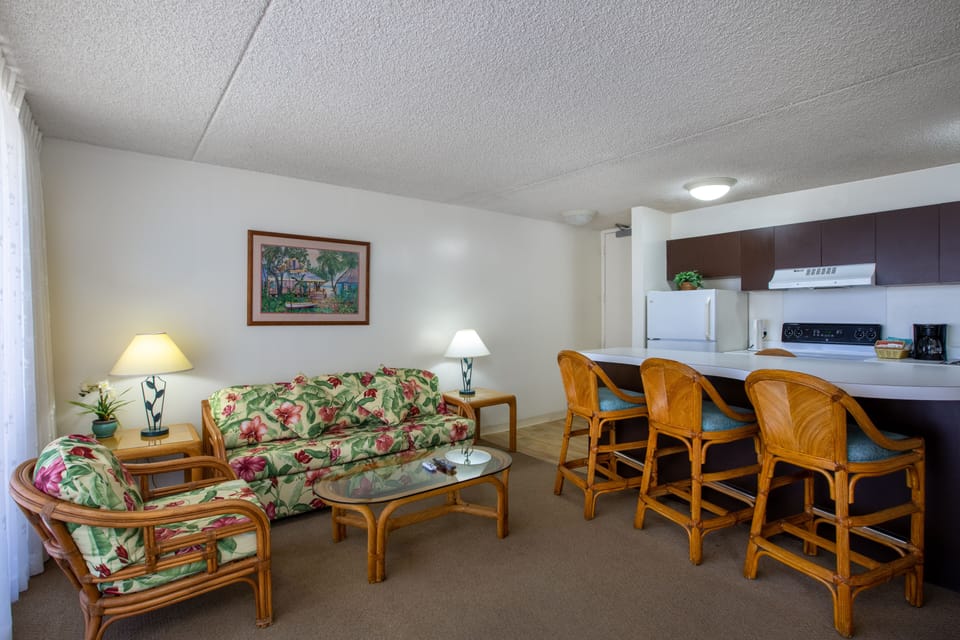 Settle into your bright, open living space with tropical-style seating, a fully equipped kitchen with bar seating, and all the comforts you need to feel right at home.