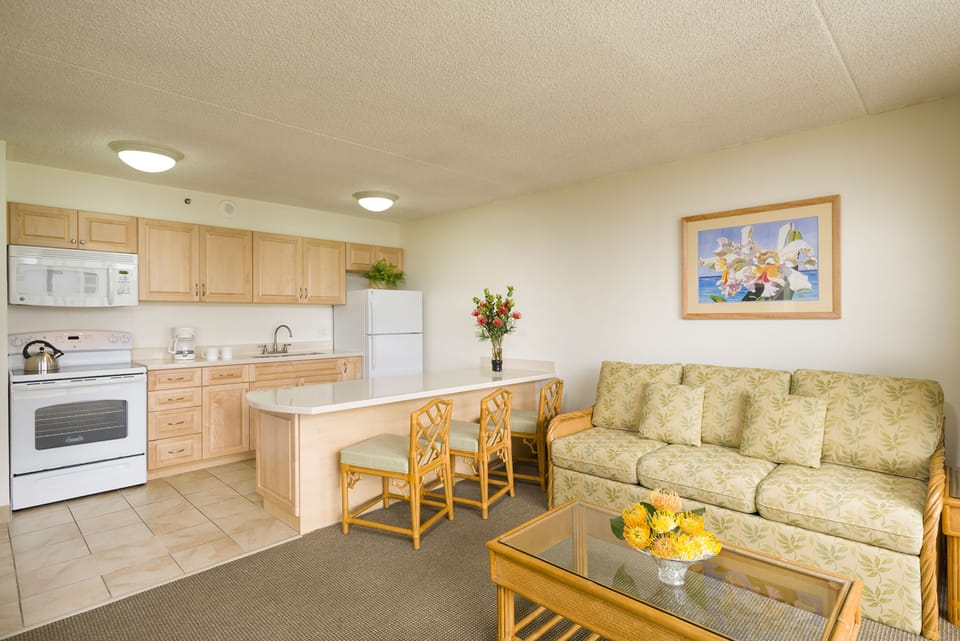 Your open-concept space flows seamlessly from kitchen to living area, offering a welcoming retreat with coastal charm, light wood accents, and cheerful touches throughout.