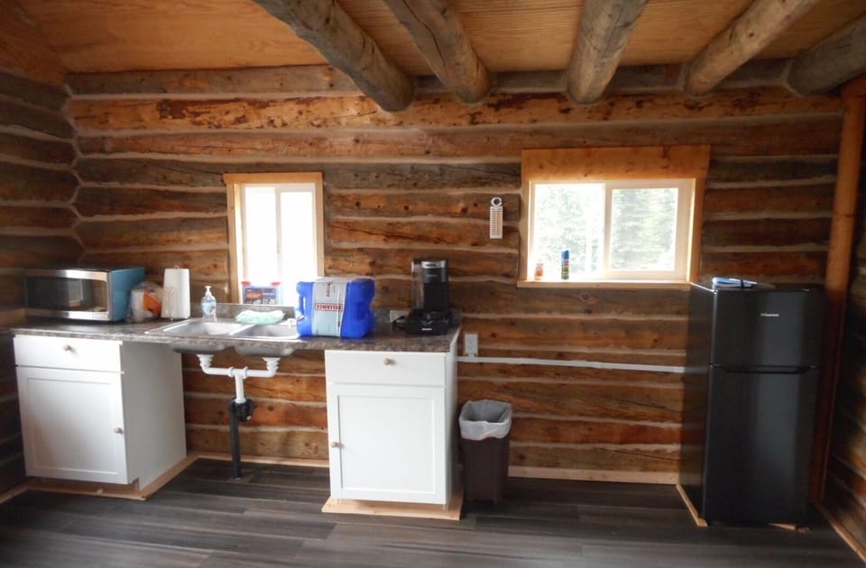 Kitchen with sink, microwave, small refrigerator and Keurig coffeemaker 
