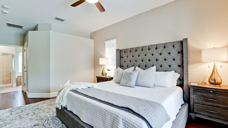 Master bedroom with king sized bed, attached bathroom and large walk in closet.
