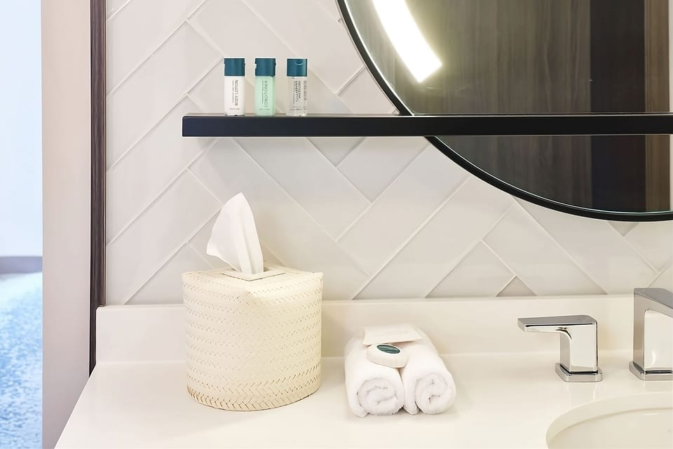 Refresh at a glowing vanity with plush towels ready.