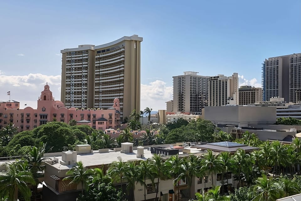 Take in the vibrant skyline framed by swaying palms.