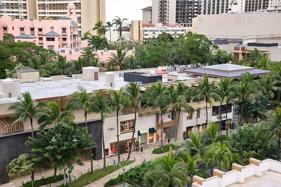 Stroll below to shops and cafés under tropical greenery.