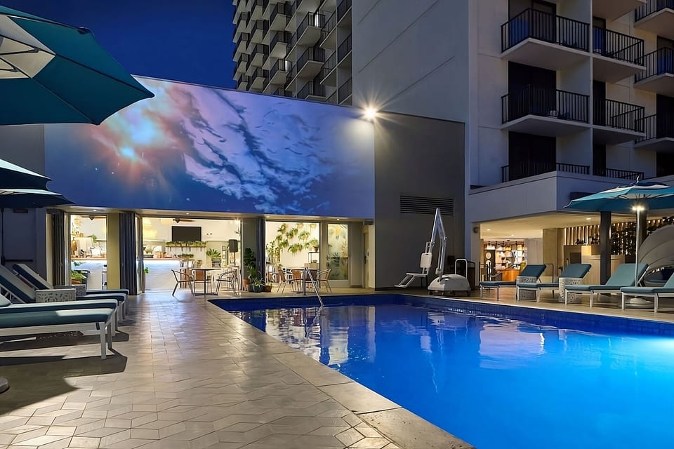 Linger after sunset with shimmering water and lounge lighting.
