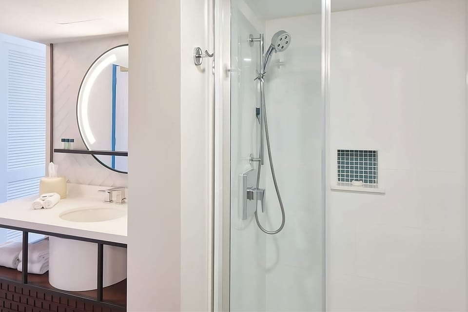 Rinse off in a sleek glass shower after beach time.