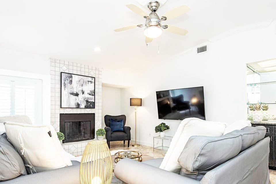 The Living room with 65 inch TV featuring a wet bar