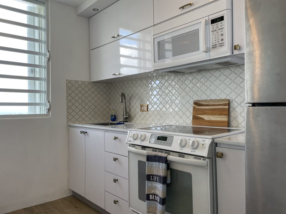 Microwave and Oven with stovetop, full sink and refrigerator