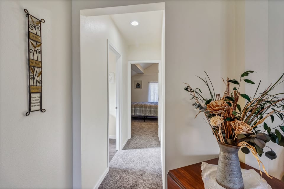 Hallway to half bath and second bedroom