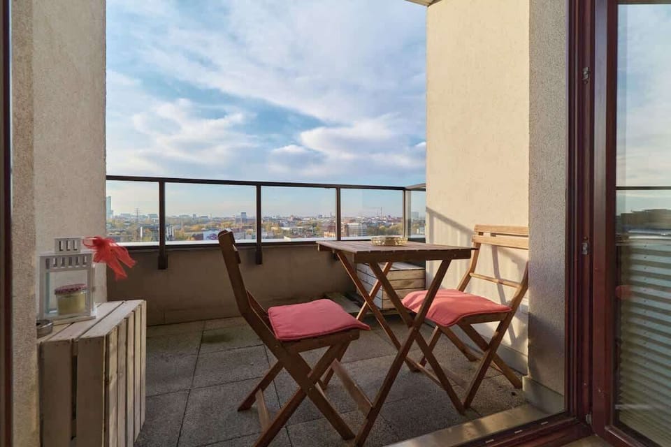 The furnished balcony offers a perfect spot for morning coffee with a view.