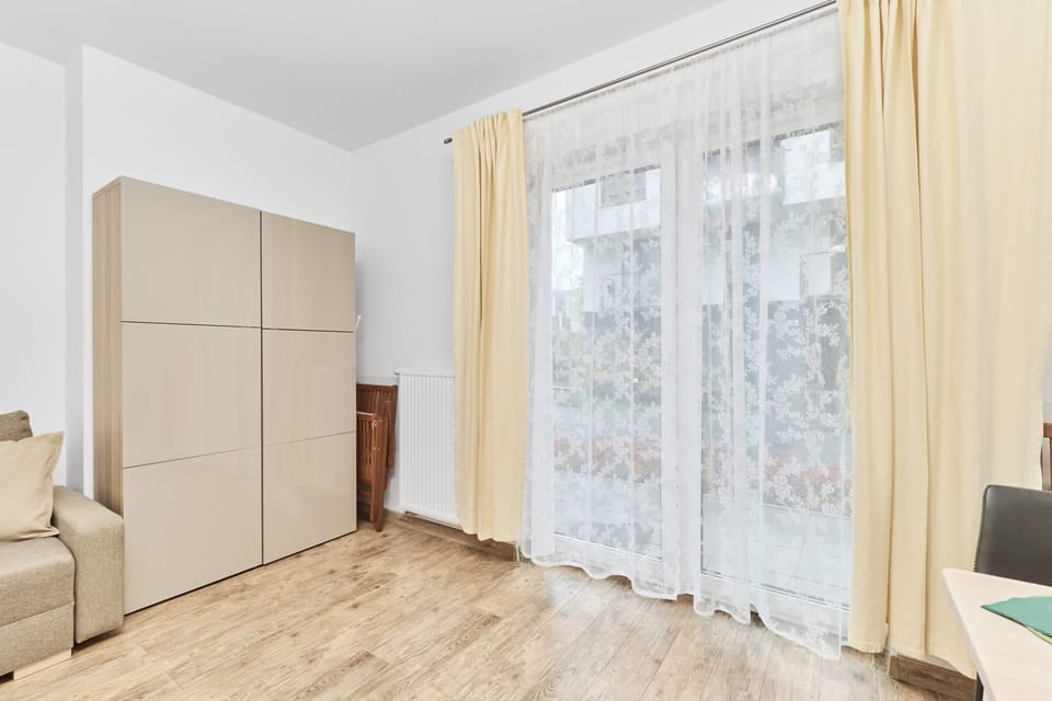 The elegant living room featuring a double sofa bed, perfect for relaxing or sleeping.