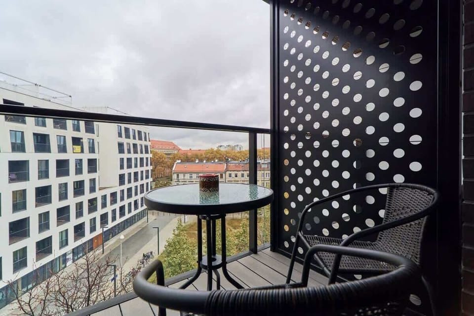 The balcony's stylish design complements the apartment's decor. 