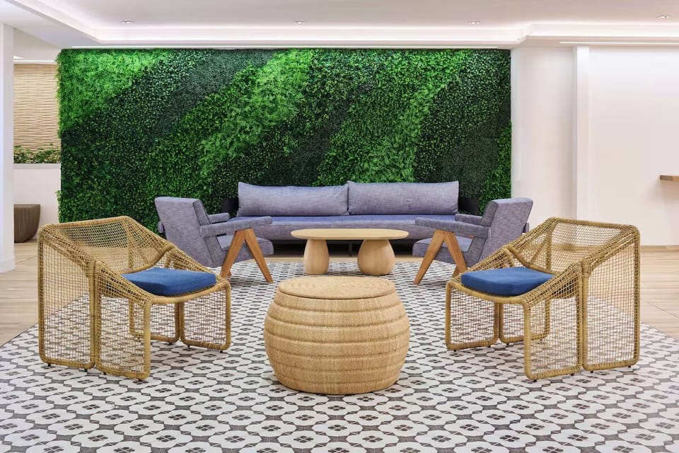 Gather comfortably on plush seating against a lush green wall.