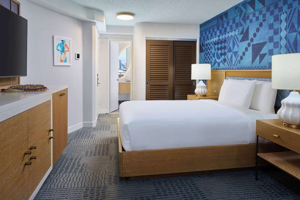 Settle into a spacious bedroom with smart storage and calm tones.