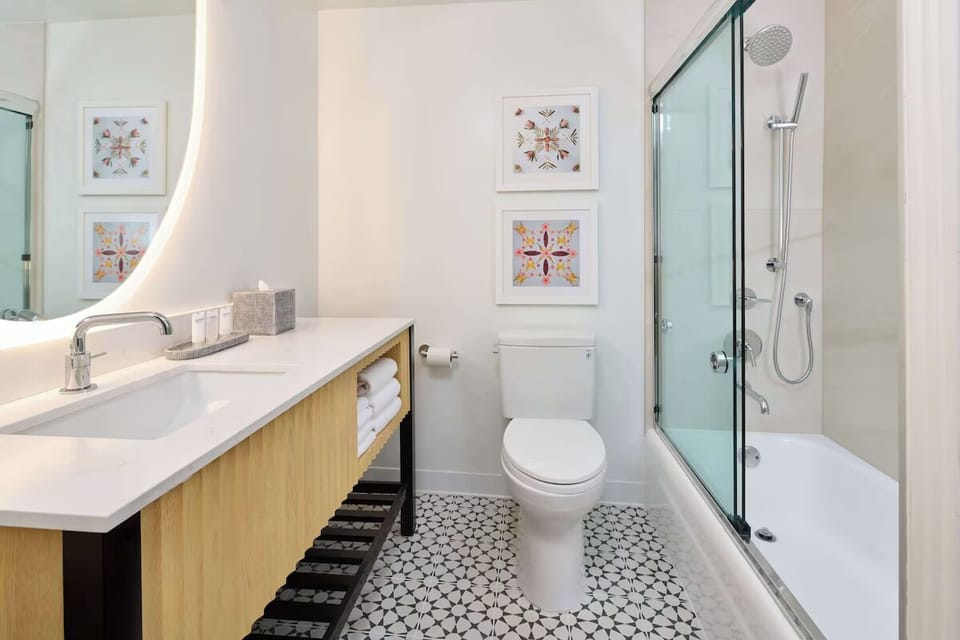 Refresh easily in a spotless bath with bright vanity lighting.