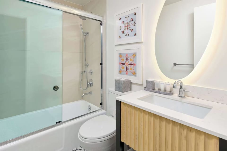 Rinse off under a modern shower with glass surround.