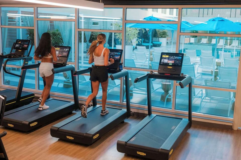 Energize your morning with treadmills and bright poolside views.