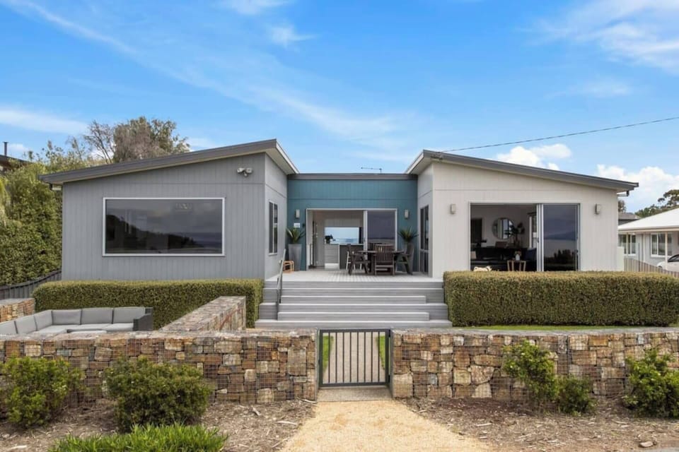 The exterior of the property features a unique U-shaped layout, enhancing the outdoor living experience and providing ample space for relaxation.