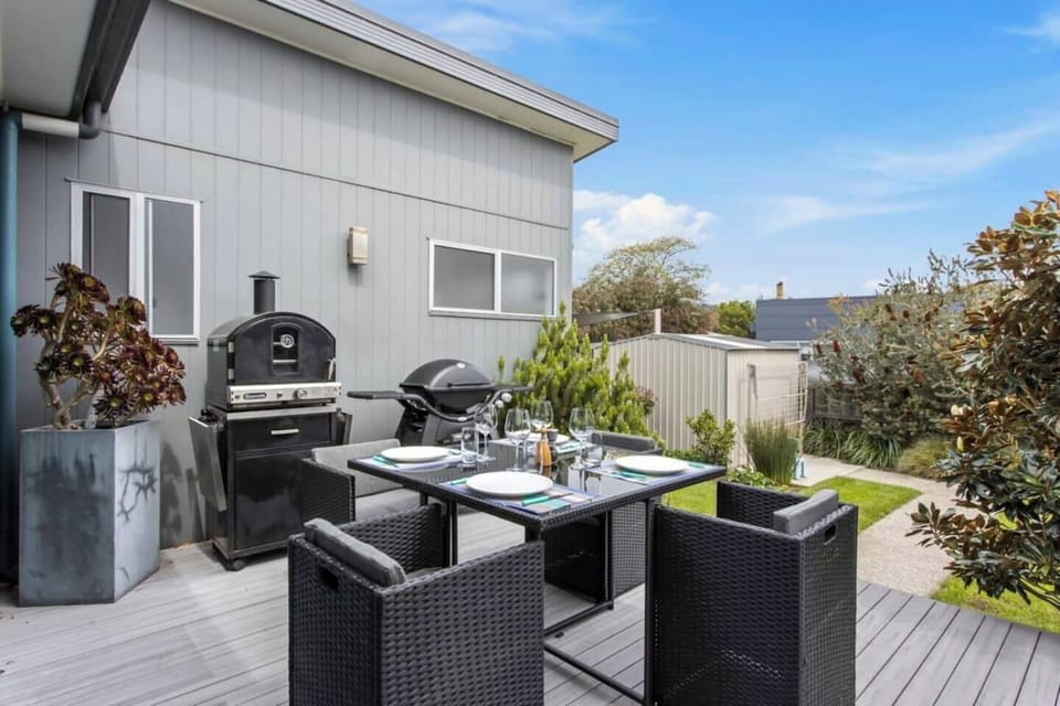 The rear deck features a dining area and BBQ, ideal for cooking up fresh meals and enjoying outdoor dining with family and friends. 

Note: the pizza oven visible in the photo is no longer available. 