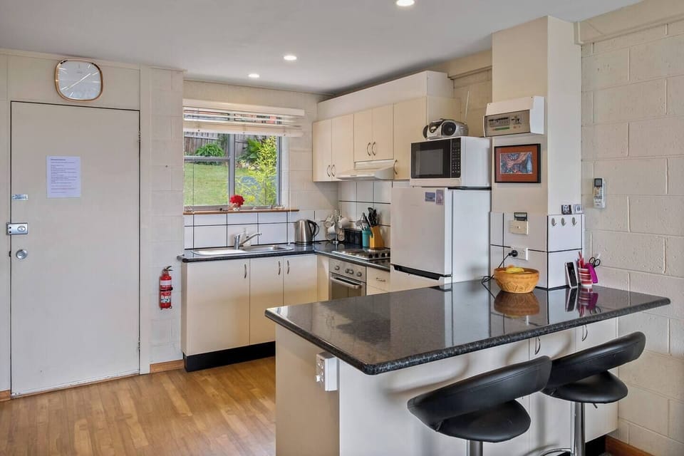 It includes modern appliances, ample counter space, and all the cookware you need for a home-cooked meal.